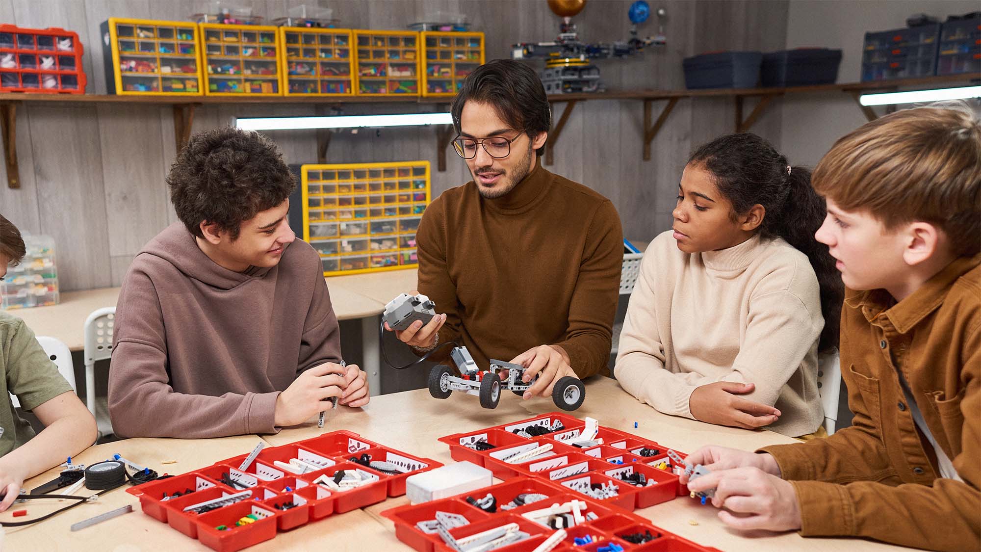 Educator and students building LEGO robots together